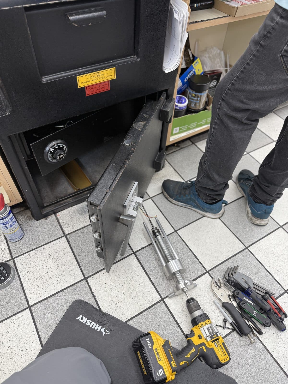 Drill rig and hand tools in front of a drop safe
