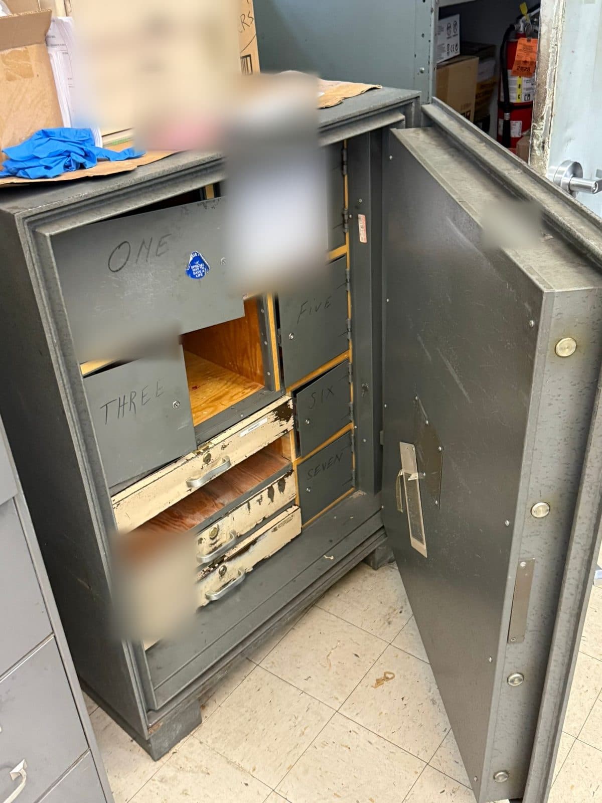 An office safe with numbered drawers, door open